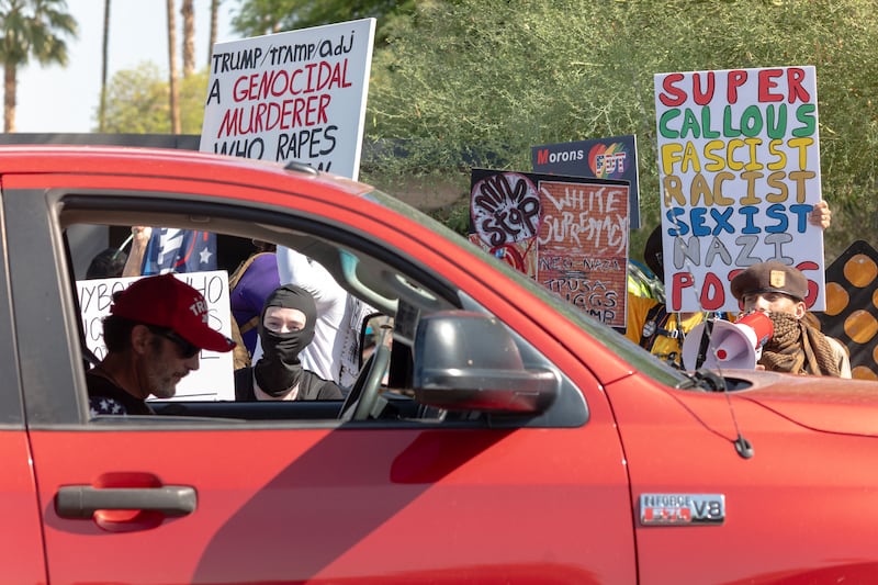 People protest the president’s visit to Arizona as attendees arrive at Dream City Church, where the Turning Point USA “Build the Red Wall” event was being held on April 17, 2026. President Trump spoke at the event by the conservative political organization founded by the late activist Charlie Kirk.