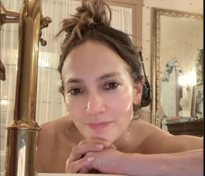 Jennifer Lopez smiles in a bathtub video as she chats about her skincare routine in an Instagram post.