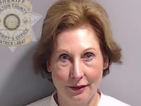 A booking photo of Sidney Powell