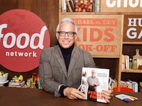 NEW YORK, NY - OCTOBER 19: Chef Geoffrey Zakarian signs copies of his book "My Perfect Pantry" at the Grand Tasting presented by ShopRite featuring KitchenAid® culinary demonstrations presented by MasterCard during the Food Network New York City Wine & Food Festival Presented By FOOD & WINE at Pier 94 on October 19, 2014 in New York City. (Photo by Larry Busacca/Getty Images for NYCWFF)