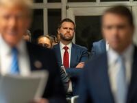 Sen. J.D. Vance (R-OH) stands behind former President Donald Trump.