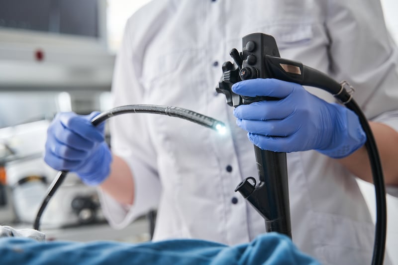 A doctor holding an endoscope during gastroscopy.
