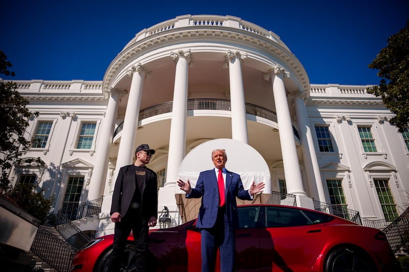 WASHINGTON, DC - MARCH 11: U.S. President Donald Trump, accompanied by White House Senior Advisor, Tesla and SpaceX CEO Elon Musk speaks next to a Tesla Model S on the South Lawn of the White House on March 11, 2025 in Washington, DC. Trump spoke out against calls for a boycott of Elon Musk's companies and said he would purchase a Tesla vehicle in what he calls a 'show of confidence and support' for Elon Musk. (Photo by Andrew Harnik/Getty Images)