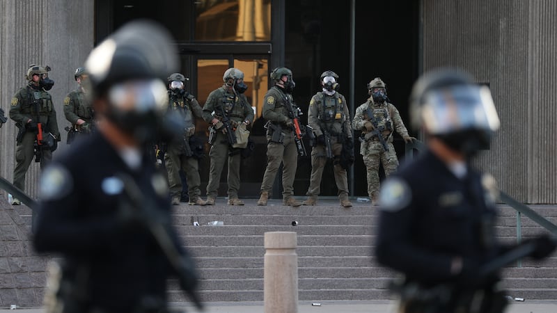 olice and US Customs and Border Protection agents outside the United States Citizenship and Immigration Services (USCIS) Santa Ana Field Office