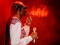 Rapper Snoop Dogg smokes as he performs during a celebration of hip hop in the Bronx at Yankee Stadium on Aug. 11, 2023.