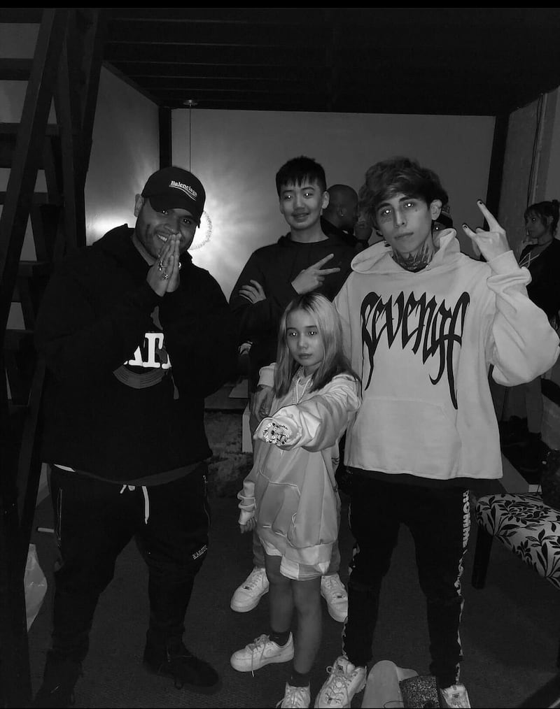 Lil Tay, center, her brother, Jason Tian, background, and their musical collaborator, Diablo, right, after a studio session.