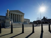 The sun casts shadows as it rises over the U.S. Supreme Court in Washington, U.S., December 20, 2023.
