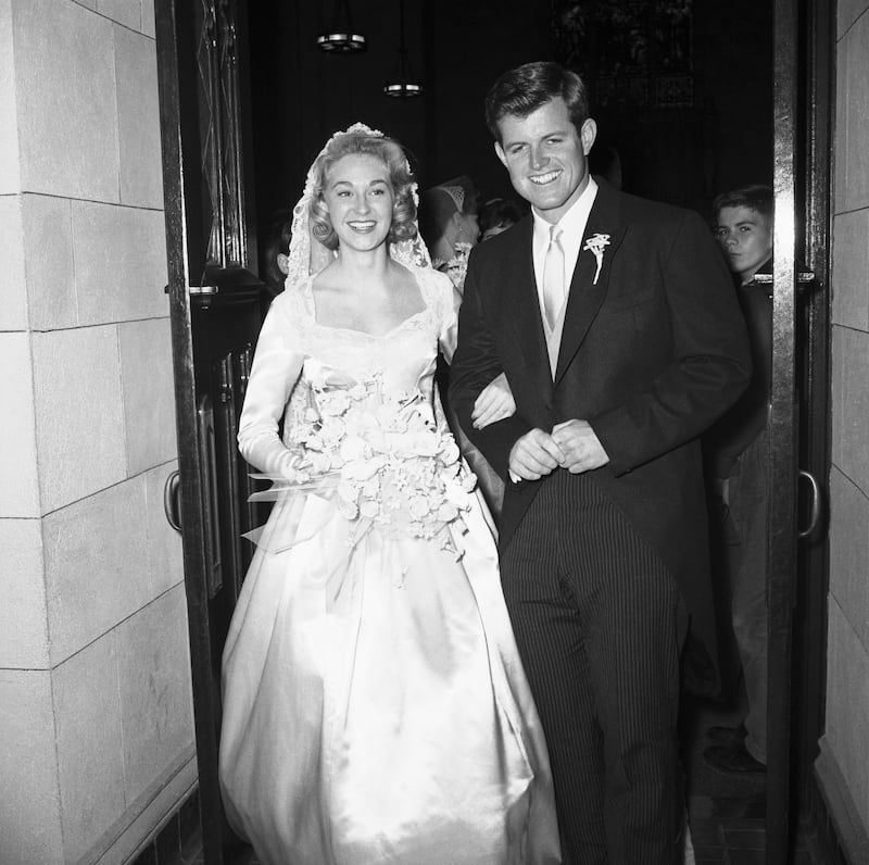 Edward Moore Kennedy, son of former U.S. Ambassador to Britain Joseph P. Kennedy, smilingly poses with his bride, post-debutante Joan Bennett, after their wedding ceremony at St. Joseph's Church