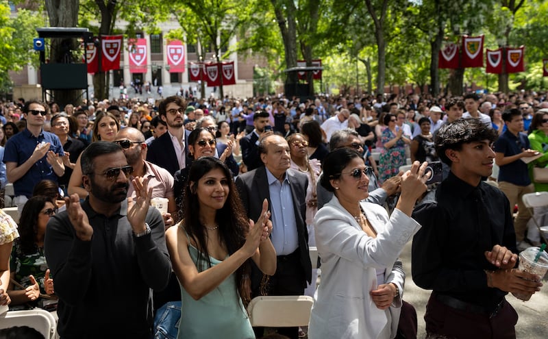 Students and families give a round of applause during Harvard's Class Day ceremony on May 28, 2025.