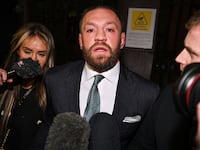 Conor McGregor leaves court in 2024.