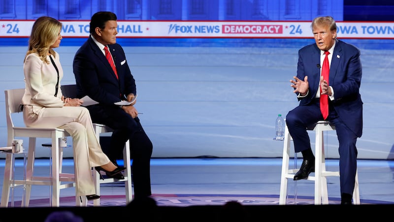 Donald Trump speaks as Fox News moderators Bret Baier and Martha MacCallum look on during a town hall in Des Moines, Iowa.