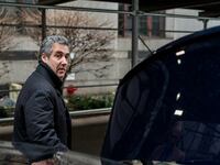 Michael Cohen steps into a car