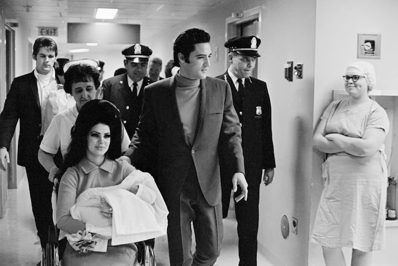 Elvis Presley with his wife and daughter as they leave Baptist Hospital in Memphis, Tennessee in 1968.