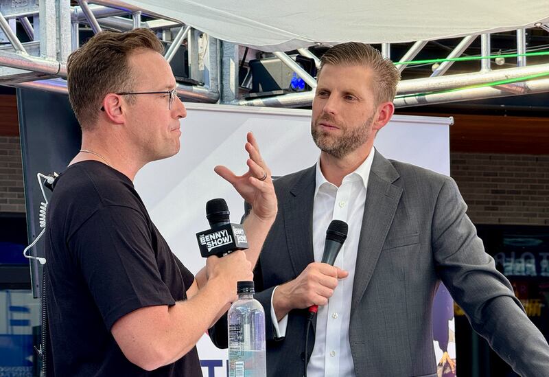 Eric Trump speaks with political commentator and YouTuber Benny Johnson (L) outside the Fiserv Forum during the second day of the 2024 Republican National Convention in Milwaukee, Wisconsin, July 16, 2024. Days after he survived an assassination attempt Donald Trump won formal nomination as the Republican presidential candidate and picked right-wing loyalist J.D. Vance for running mate, kicking off a triumphalist party convention in the wake of last weekend's failed assassination attempt.