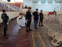 Lanao Del Sur Gov. Mamintal Adiong Jr. looks on as law enforcement officers investigate the scene of an explosion that occurred during a Catholic Mass in a gymnasium at Mindanao State University in Marawi, Philippines, Dec. 3, 2023.