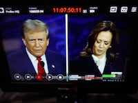 TV showing a spilt screen of Trump and Harris during the debate