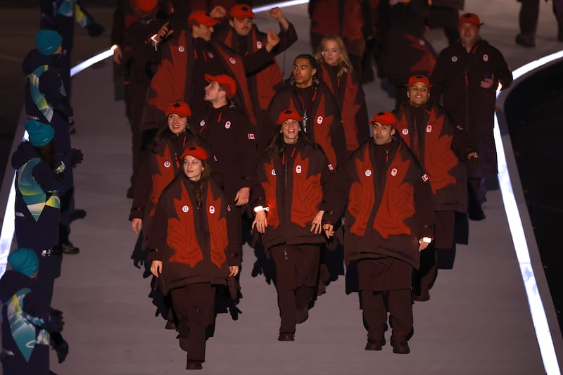 Athletes from Team Canada walk in the parade during the opening ceremony of the Milano Cortina 2026 Winter Games.
