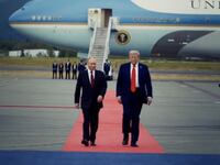 A screenshot from a video President Donald Trump posted about his meeting with Russian President Vladimir puting showing the pair walking on a red carpet in front of Air Foce One.