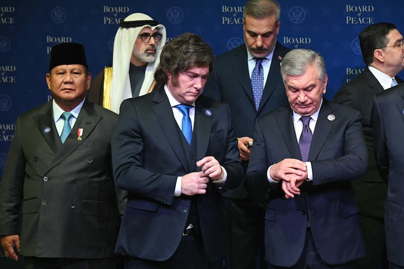 Indonesia's President Prabowo Subianto, Argentina's President Javier Milei, and Uzbekistan's President Shavkat Mirziyoyev wait around for a group photo during the inaugural meeting of the "Board of Peace" hosted by President Donald Trump at the US Institute of Peace in Washington, DC, on February 19, 2026.