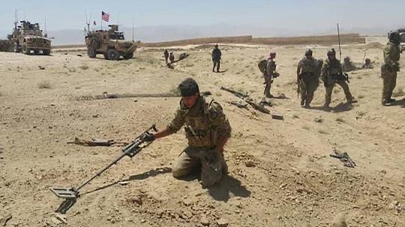 Abdul Rahman Waziri searching for improvised explosive devices in Afghanistan.