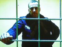 Alexei Navalny is seen on a screen via video link from the IK-2 corrective penal colony in Pokrov before a court hearing to consider an appeal against his prison sentence, in Moscow, Russia, May 17, 2022.
