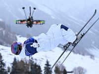 A broadcast drone hovers as Britain's Makayla Gerken Schofield competes in the freestyle skiing women's moguls qualification 1 during the Milano Cortina 2026 Winter Olympic Games
