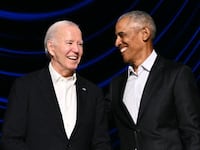 U.S. President Joe Biden (L) laughs with former President Barack Obama onstage during a campaign fundraiser at the Peacock Theater in Los Angeles.