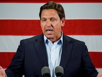 Ron DeSantis speaks in front of a U.S. flag