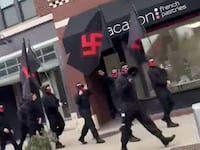 A video still shows a group of neo-Nazis marching in downtown Columbus, Ohio.