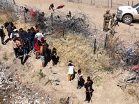 Migrants attempting to cross the North American side of the border between El Paso and Ciudad Juarez, Mexico.