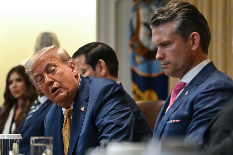 Donald Trump speaks alongside Secretary of Defense Pete Hegseth and Secretary of Commerce Howard Lutnick during a cabinet meeting in the Cabinet Room of the White House in Washington, DC,