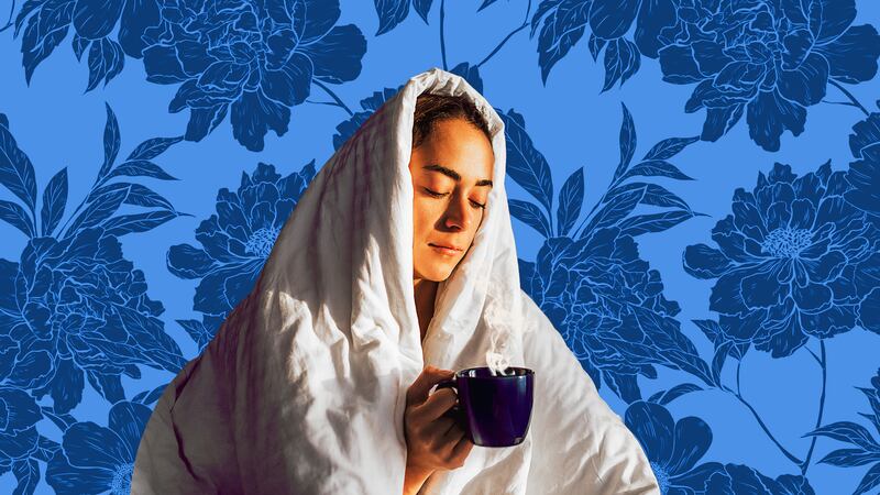 A woman wrapped in a weighted blanket.