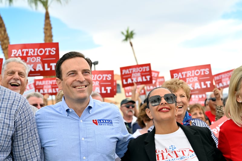 Nevada Republican U.S. Senate nominee Adam Laxalt (L) poses with Nevada Attorney General candidate Sigal Chattah for a group photo during a "Get Out The Vote" campaign rally on October 22, 2022 in Las Vegas, Nevada.