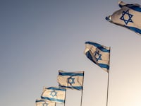 Several flags of Israel flying outside the historic Old City of Jerusalem in Israel.