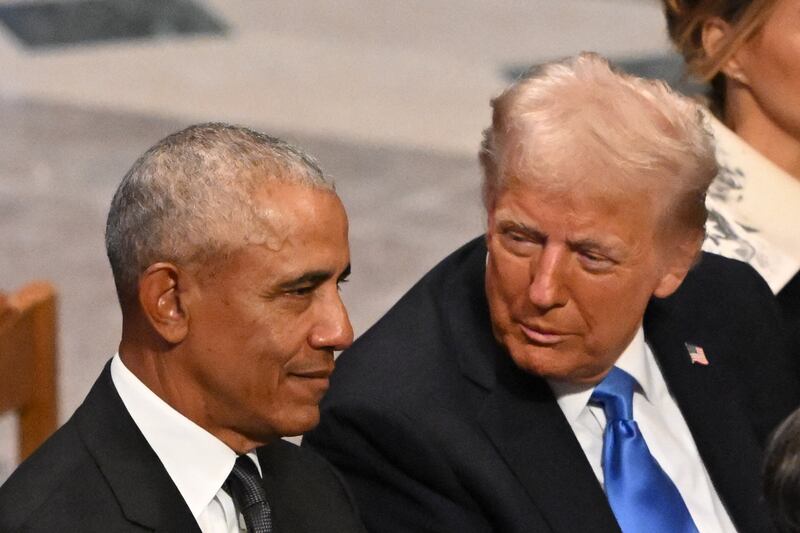 Donald Trump speaks with Barack Obama as they attend the State Funeral Service for former US President Jimmy Carter at the Washington National Cathedral in Washington, DC, on January 9, 2025.