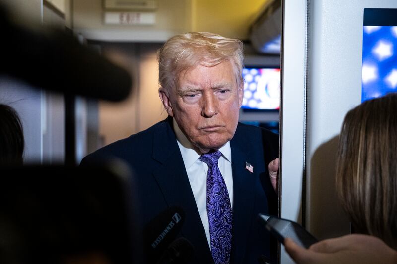 President Donald Trump speaks to the press aboard Air Force One en-route to Washington, DC on November 30, 2025.