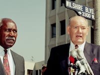 Los Angeles Politician Nate Holden (L) listens to Los Angeles City Council Member John Ferraro