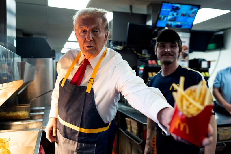 FEASTERVILLE-TREVOSE, PENNSYLVANIA - OCTOBER 20: Republican presidential nominee, former U.S. President Donald Trump works behind the counter during a campaign event at McDonald's restaurant on October 20, 2024 in Feasterville-Trevose, Pennsylvania.