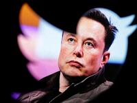 Elon Musk's photo is seen through a Twitter logo in this illustration taken October 28, 2022.