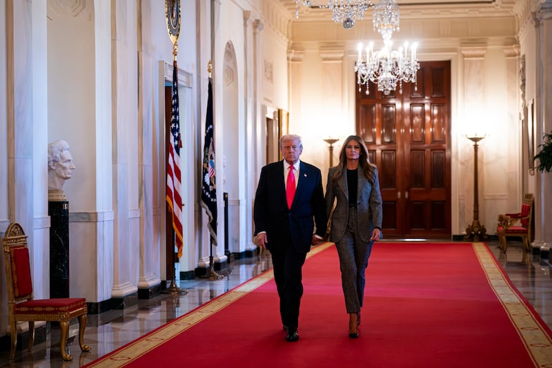 President Donald Trump and First Lady Melania Trump arrive to sign an executive order on foster children and families in the East Room of the White House on November 13, 2025 in Washington, DC.