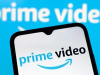 The Amazon Prime Video logo appears on the screen of a smartphone and in the background on the computer screen in Reno, United States, on December 15, 2024.