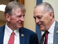 A photo of Reps. Paul Gosar and Andy Biggs, chatting and grinning.