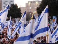 Israeli protesters wave dozens of Israel flags.