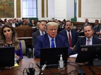 Former President Donald Trump sits in court with his attorneys Alina Habba and Christopher Kise