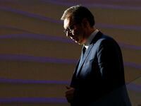 Serbia's President Aleksandr Vucic walks down stairs.