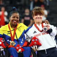 Gold medallist Clara Sarahy Fuentes Monasterio of Venezuela celebrates with her medal on the podium along with silver medallist Jinping Xiao of China and bronze medallist Olivia Broome of Britain