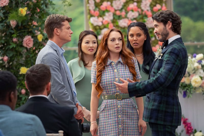Lindsay Lohan stands between Ed Speelers and Alexander Vlahos in a still from ‘Irish Wish’
