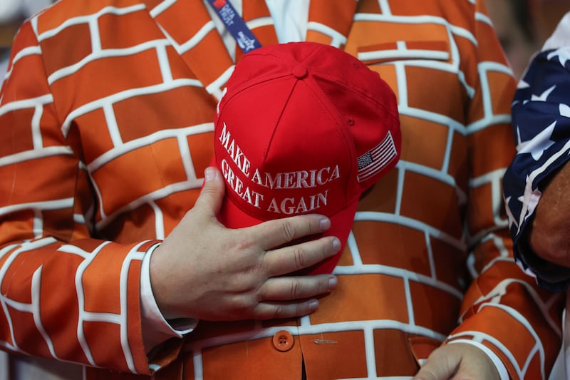 DALLAS, TEXAS - SEPTEMBER 09: Blake Marnell, wearing a suit jacket with bricks representing a border wall holds a MAGA hat as he attends the first day of the 2026 Republican National Convention at the American Airlines Center on September 09, 2026 in Dallas, Texas. U.S. President Donald Trump will headline the Republican National Committee's first-ever midterm convention as he aims to highlight his administration’s achievements and rally support for GOP candidates just two months before the upcoming elections being held on November 3. (Photo by Kevin Dietsch/Getty Images)