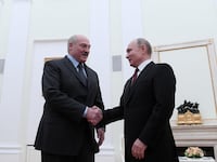 Vladimir Putin shakes hands with Alexander Lukashenko in Moscow.