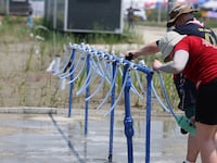 Participants for the 25th World Scout Jamboree fill water bottles at a water supply zone of a camping site in Buan, South Korea, August 2, 2023.